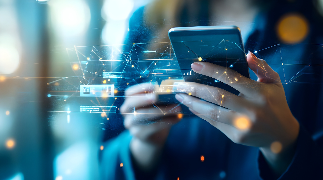 A close-up of a person holding a smartphone, overlaid with glowing lines, graphs, and network icons representing digital data. The image is accented with blue and orange lights, creating a futuristic and cyber-inspired atmosphere.